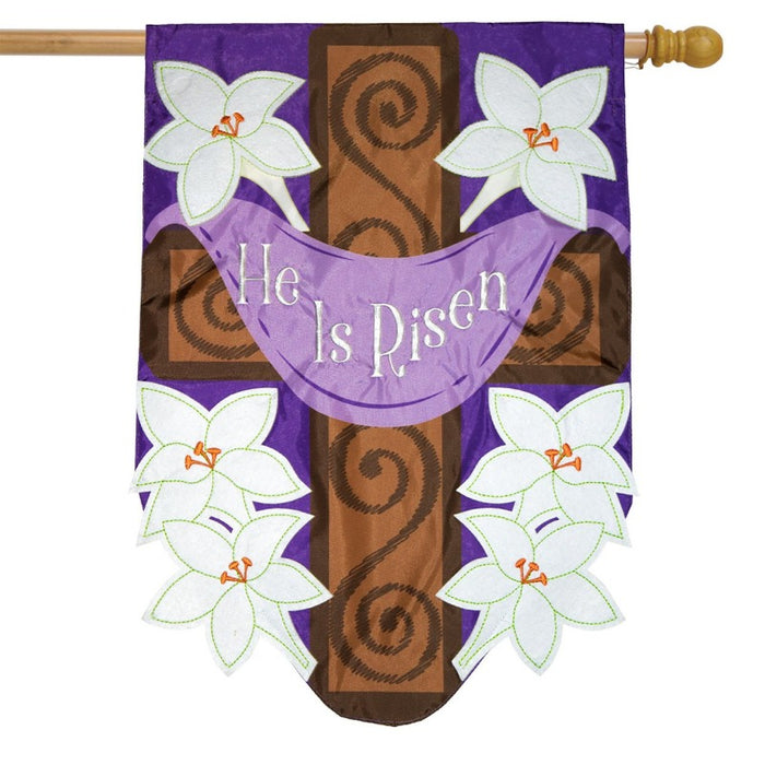 purple applique flag with cross and white lilies and purple banner saying "he is risen"