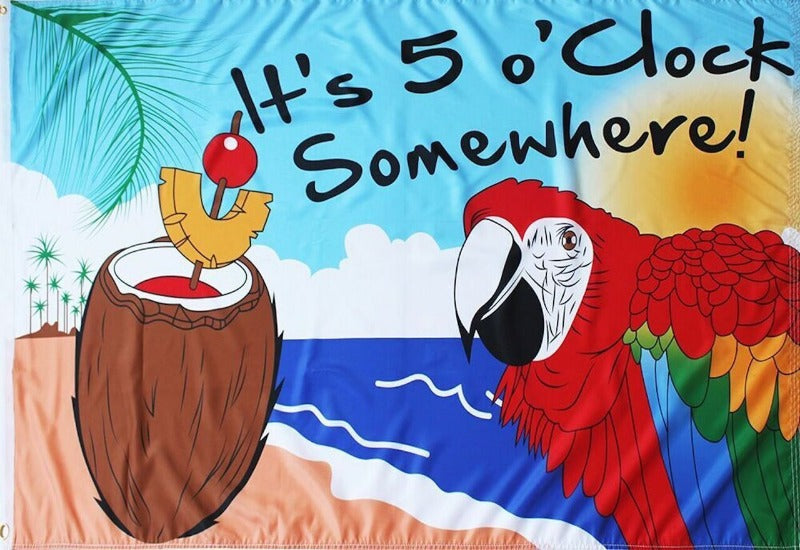 parrot with a coconut drink on the beach with text saying "it's 5 o'clock somewhere"