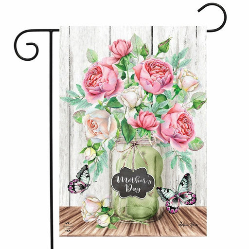 wooden background flag with roses coming out of a mason jar and the words "mother's day"